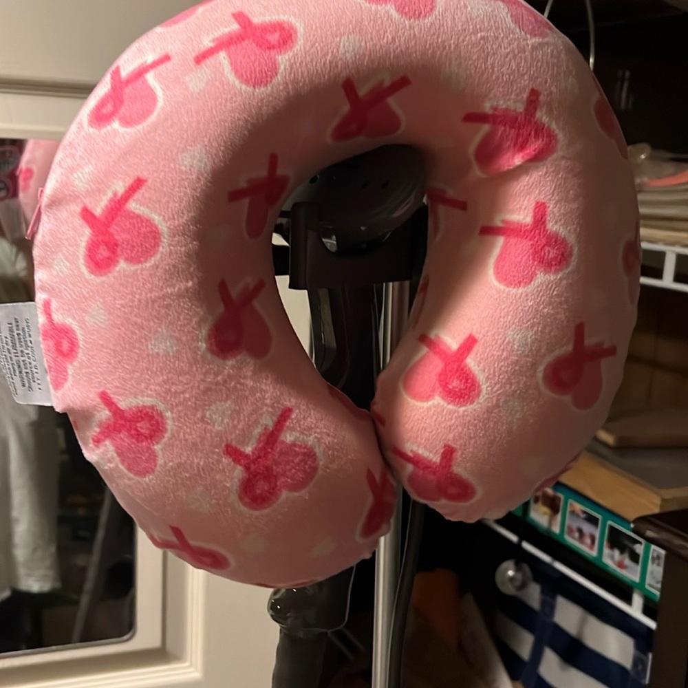 Memory foam travel pillow. Breast cancer awareness theme.